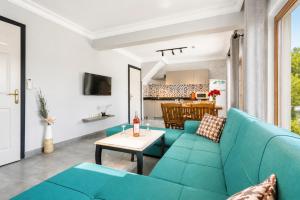 a living room with a blue couch and a table at Villa Deniz Paradise in Dalyan