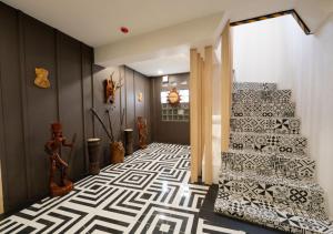 a hallway with a white and black patterned floor at 3BU Hostel Baguio - Bonifacio in Baguio