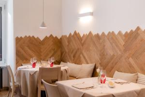 a dining room with two tables with white tablecloths at Hotel Valeria in Villa Opicina