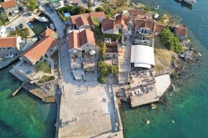 an aerial view of a house on an island in the water at BlueWave Apartments in Tivat