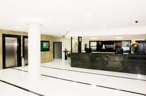 a lobby of a building with a reception desk at San Marino Cassino Hotel in Balneário Camboriú