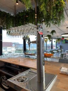 a bar with wine glasses hanging above a counter at Hotel VIDA Devalar Do Mar in Camariñas