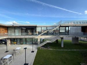 a building with a staircase and tables and chairs at Hotel VIDA Devalar Do Mar in Camariñas