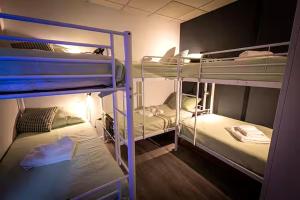 a room with three bunk beds in a room at CyberHostel Almada in Almada