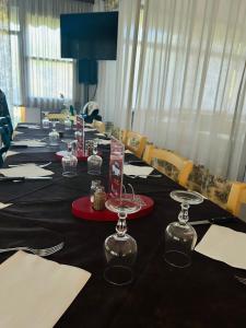 a long table with black tablecloths and napkins at HOTEL CONCORDIA in Montecatini Terme