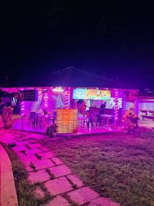 a lit up building with pink lights in front of it at Shiva Valley Retreat in Calangute +9 photos