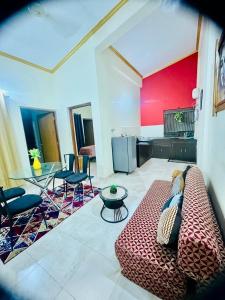 a living room with a couch and a red wall at Shiva Valley Retreat in Calangute