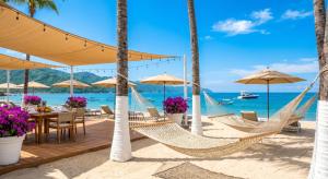 a beach with chairs and hammocks and the ocean at ICON Oceanview Retreat by Monyxbnb in Puerto Vallarta
