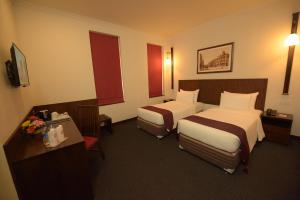 Rúm í herbergi á Hotel Nippon Colombo