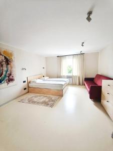 a bedroom with a bed and a couch at Loft Hause Sopot in Sopot