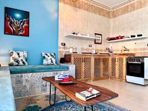 a living room with a table and a kitchen at Lighthouse Residence in Dahab