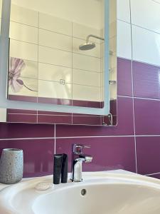 a bathroom with a sink and a mirror at Vila Llaka in Himare