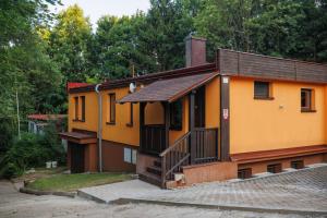 a small yellow house with a brown roof at Pastvinka in Pastviny