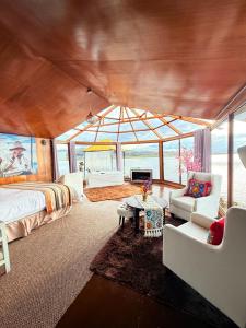 a large room with a bed and a couch at KAY PACHA LODGE Uros in Puno