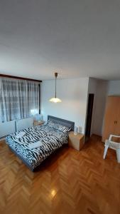 a large bed in a room with a wooden floor at Zdravo Homolje in Petrovac na Mlavi
