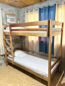 a couple of bunk beds in a room at Uya Mina Homestay in General Luna