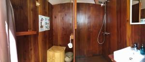 a wooden bathroom with a shower and a sink at Le Cocon de Tranquillité au Cœur de la Campagne in Les Pégués +20 photos