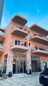 a large building with balconies on the side of it at Vila Llaka in Himare +43 photos