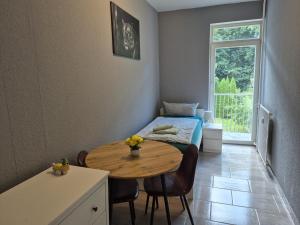 a room with a table and a bed and a window at Flensburg Strandnah in Flensburg
