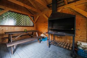 a room with a stove and a bench in a cabin at Pastvinka in Pastviny