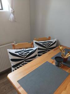 a dining room with a wooden table and chairs at Apartament Biała Przystań in Nowy Sącz