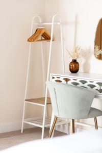 a white desk and a chair next to a table at Super Central - Quiet - 2 Bedroom Cottage in Shrewsbury