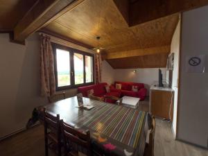 a living room with a table and a couch at Le Chasseral in Maîche +17 photos