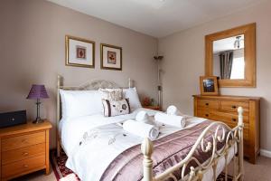 a bedroom with a white bed with towels on it at 4 Bedroom Town House with Parking in Shrewsbury +46 photos