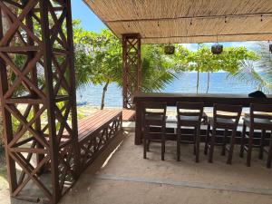 a restaurant with a table and chairs and the water at Uya Mina Homestay in General Luna