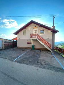 a house with a staircase in a parking lot at Filip in Sarajevo