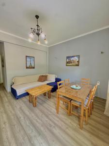 a room with a bed and a table and a bed and a dining room at Captain Michalis house in Parga