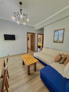 a bedroom with two beds and a wooden table at Captain Michalis house in Parga