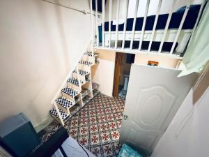 a hallway with a staircase leading up to a room at El europeo in Santo Domingo