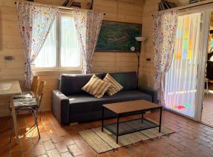 a living room with a couch and a table at Siedlisko Konradówka in Olecko