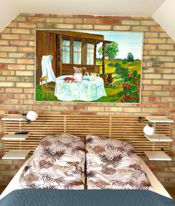 a room with a table and a painting on the wall at Siedlisko Konradówka in Olecko