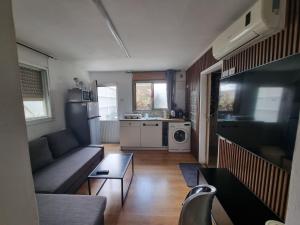 a living room with a couch and a table at OSHER Simple house in Nahariyya