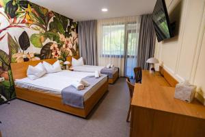 a hotel room with two beds and a television at Hotel Sveti Vasilii Veliki in Gabrovo +19 photos