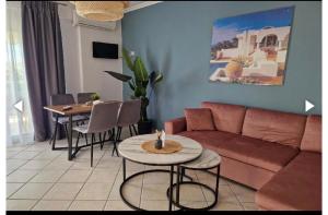 a living room with a couch and a table and chairs at Vryzas Resort in Ofrínion +46 photos