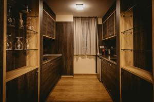 a kitchen with wooden cabinets and shelves and a window at Hotel ZOO Sofia in Sofia +252 photos