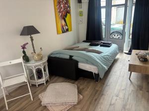 a bedroom with a bed and a table with a fireplace at Petite halte à Volnay in Volnay