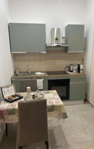 a kitchen with a table and a sink at Appartamenti Del Pesco in Trapani