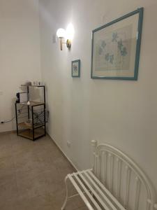 a room with a crib and a picture on the wall at Appartamenti Del Pesco in Trapani +16 photos