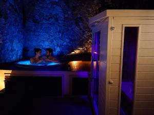 two people in a bath tub at night at SPA SUITE SICILIA - Suite con Spa privata ad uso esclusivo Jacuzzi Sauna Hammam in Rosolini