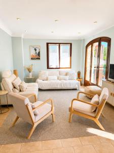 a living room with two couches and two chairs at Villa Lavendel in Montauroux