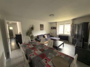 a living room with a table and a couch at Au cœur de Maîche in Maîche +24 photos