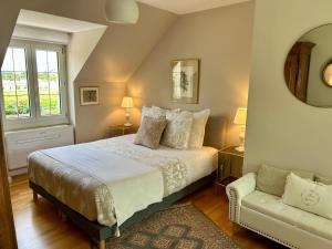 a bedroom with a large bed and a couch at Rêves & Rivière in Rivière +54 photos