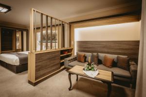 a room with a couch and a bed and a table at Hotel ZOO Sofia in Sofia