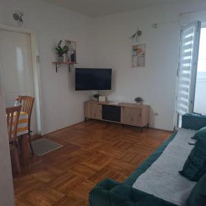a living room with a flat screen tv on the wall at Top Topla - Herceg Novi in Topla
