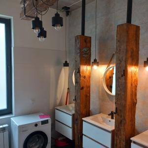 a bathroom with a washing machine and a sink at Noclegi Kolejowa in Rybnik +21 photos