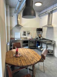 a large kitchen with a wooden table and chairs at Noclegi Kolejowa in Rybnik